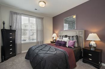 a bedroom with a bed and two dressers and a window  at Watermark on Twenty Mile, Colorado